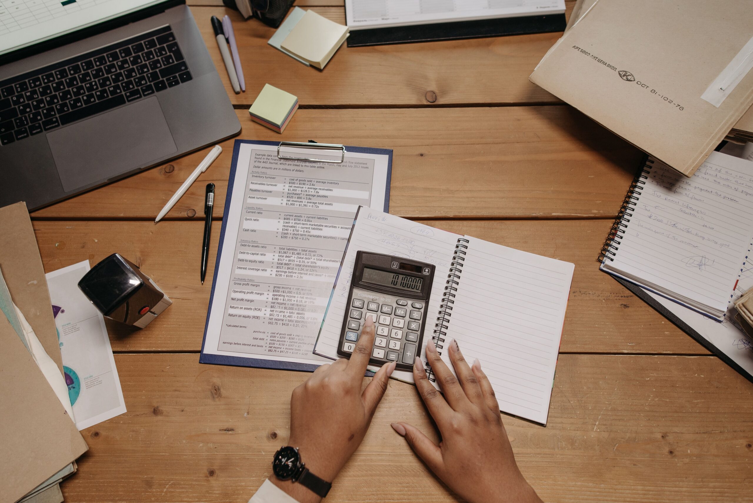 Offshore bookkeeper reviewing invoices and financial records